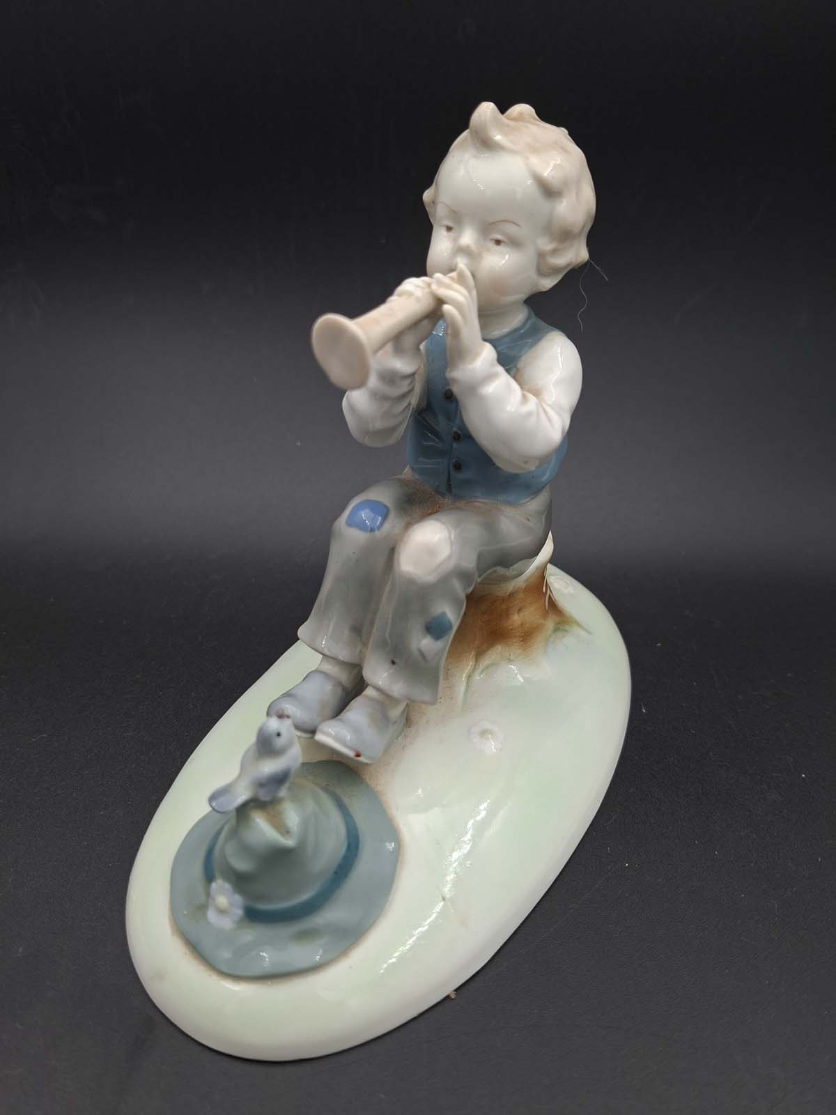 Boy Playing the Flute by Metzler & Ortloff